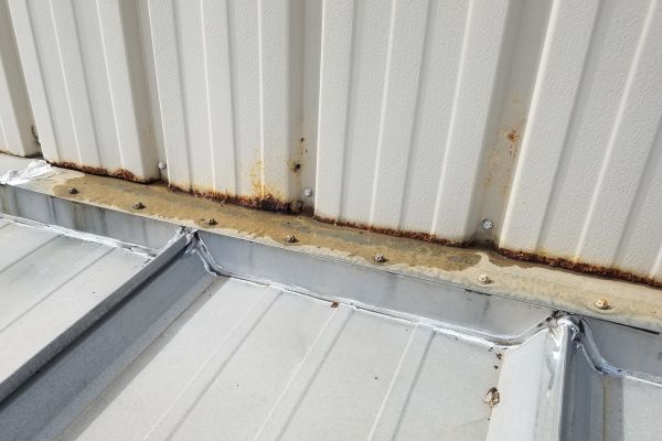 metal wall rusting and leaking