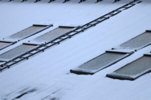 Metal roof of a commercial building covered by snow.