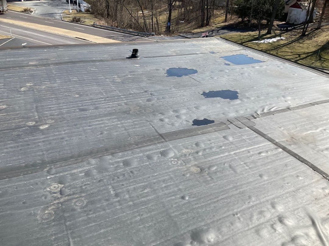 a poorly executed EPDM roofing installation that an expert contractor could have avoided