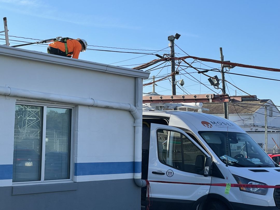 Moser roofer practicing good commercial roofing safety by tying off