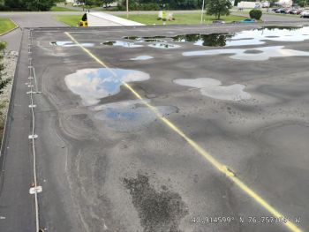 ailing roof with ponding water in need of a new PVC roof installation