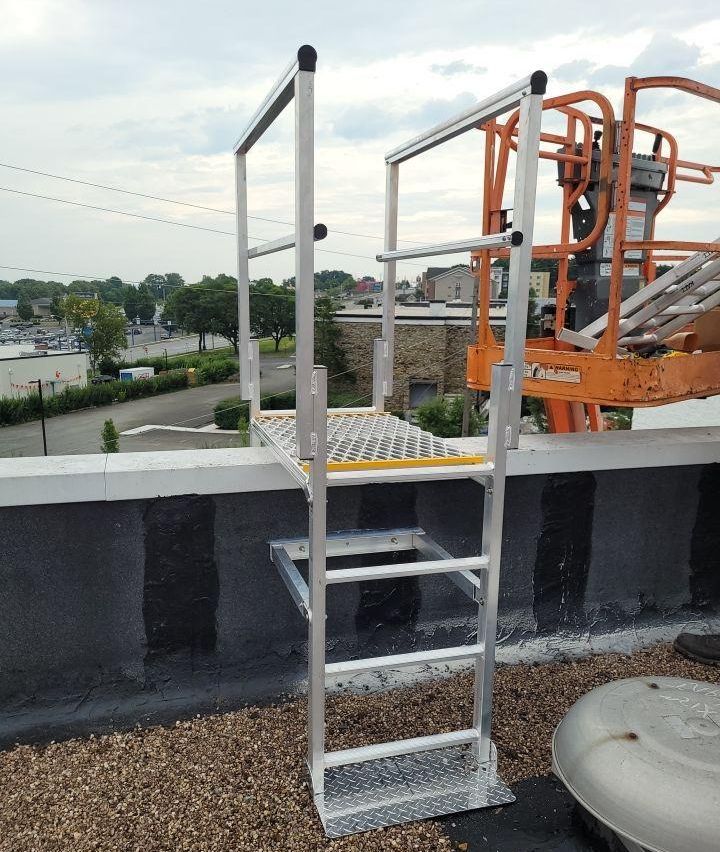 On the edge of a commercial rooftop, performing a maintenance job.