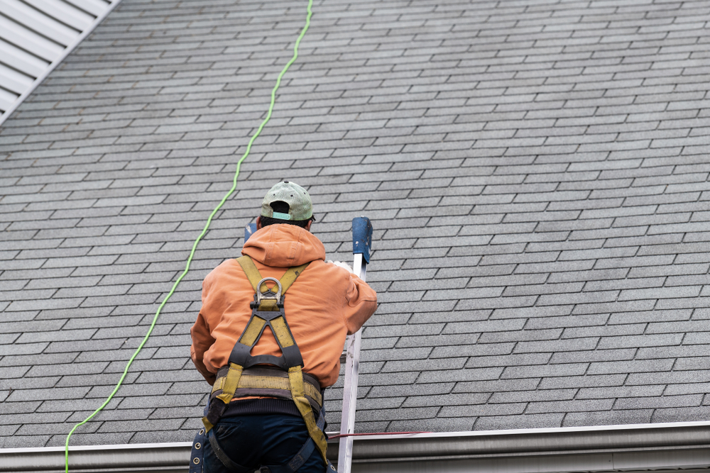 Roofer climbing a roof