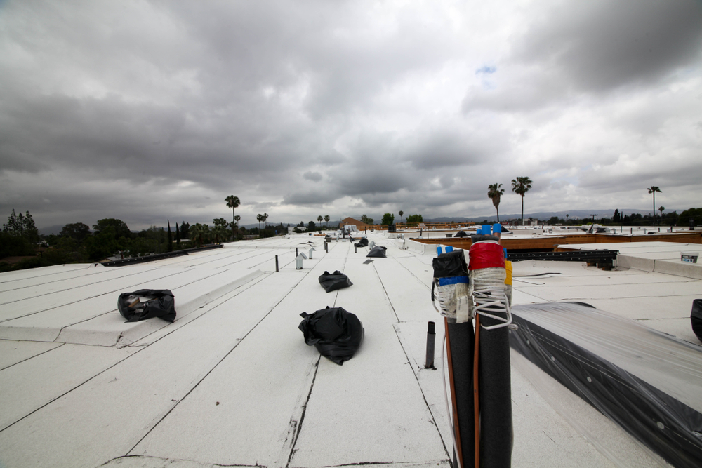 Industrial roofing with cloudy sky in the background.