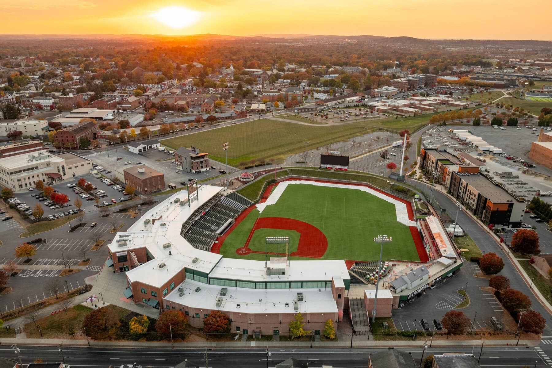 a baseball field and a city