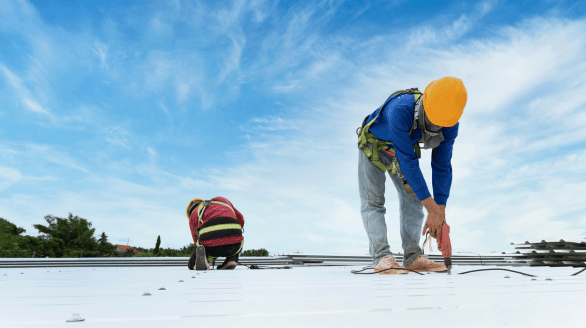 a group of construction workers working on a roof