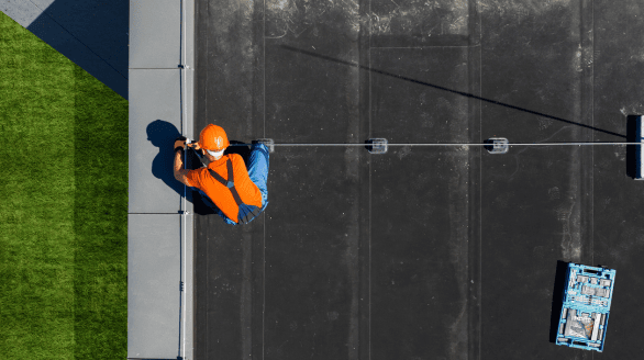 a man wearing a helmet and holding a tool