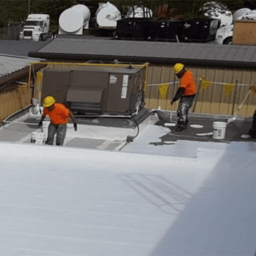 a group of men painting a roof