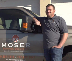a man standing next to a truck