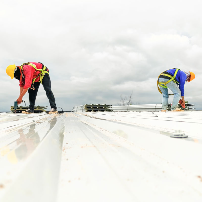 a group of men working on a roof