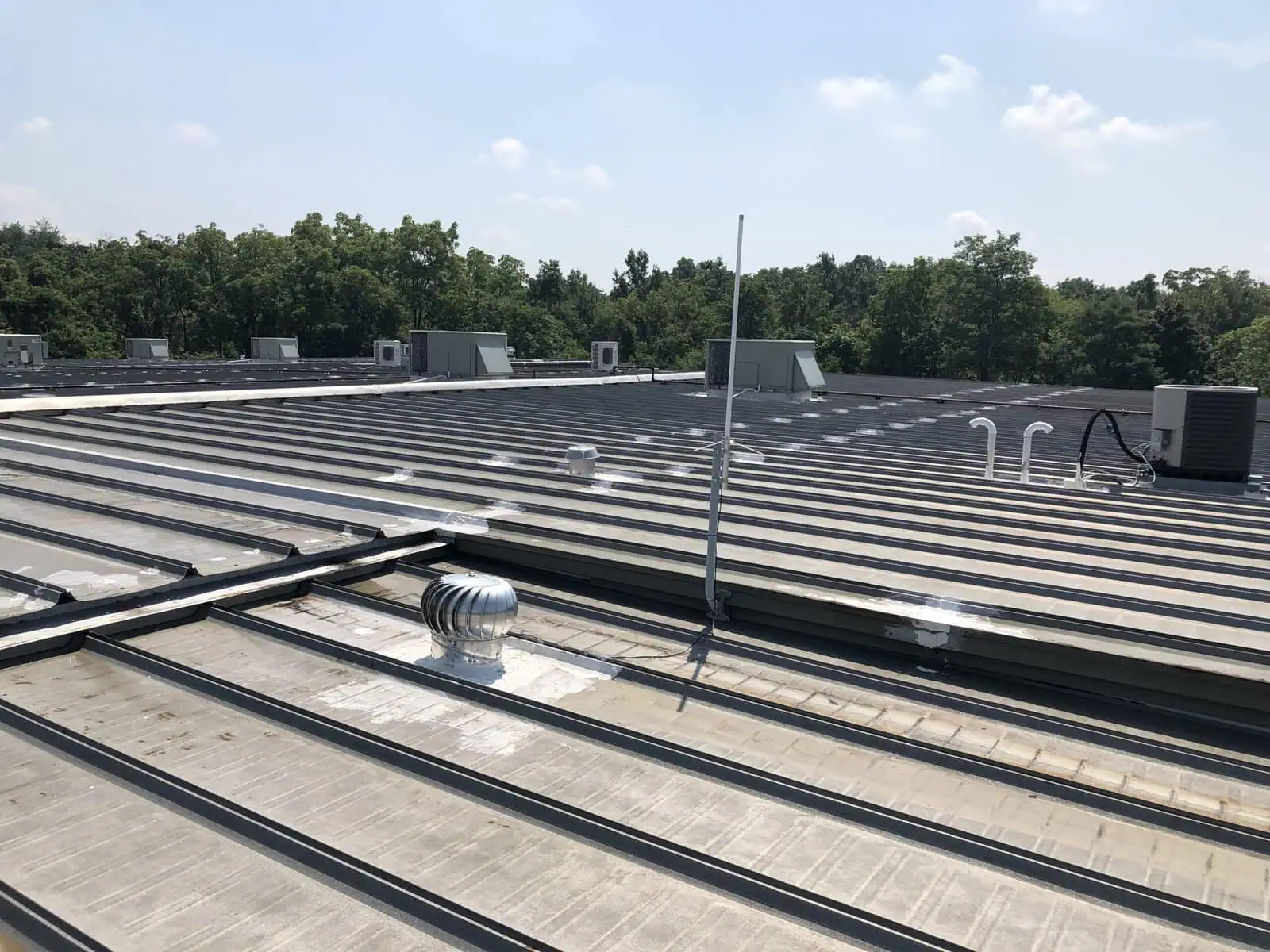a roof of a building with trees in the background