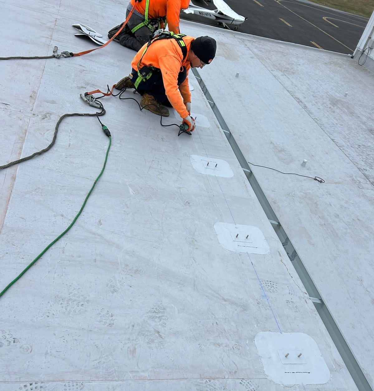 a group of men working on a roof