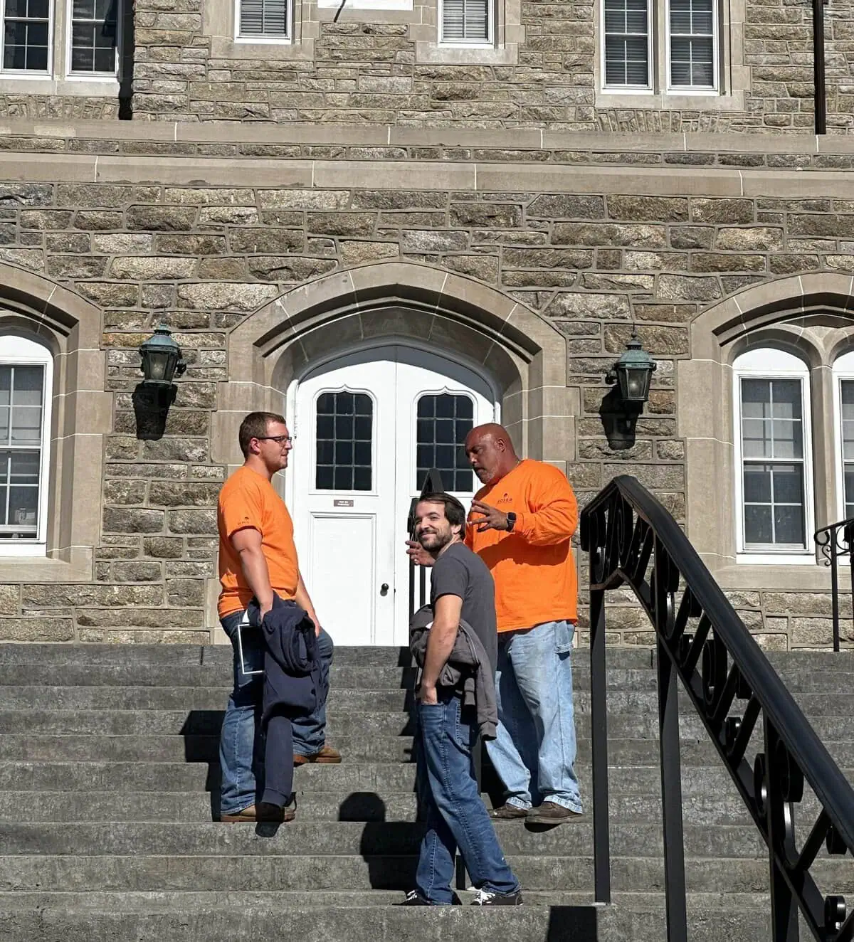 a group of men standing on stairs outside a building