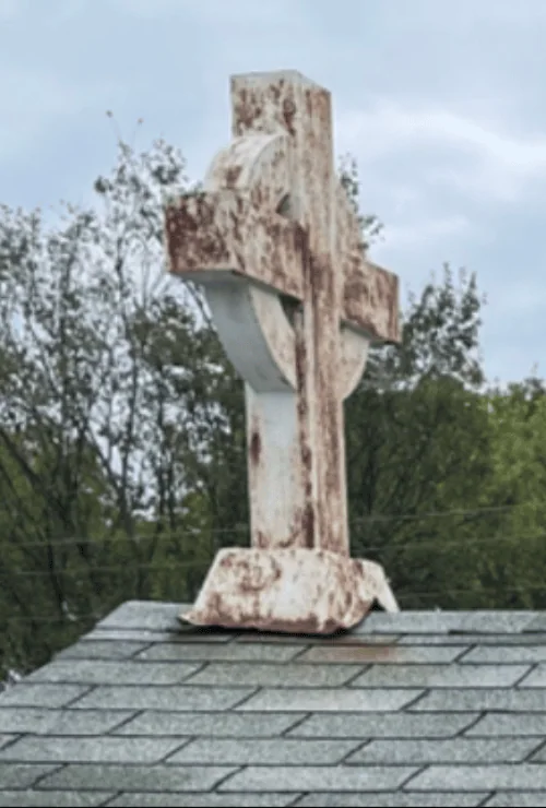 A dirty cross on a church