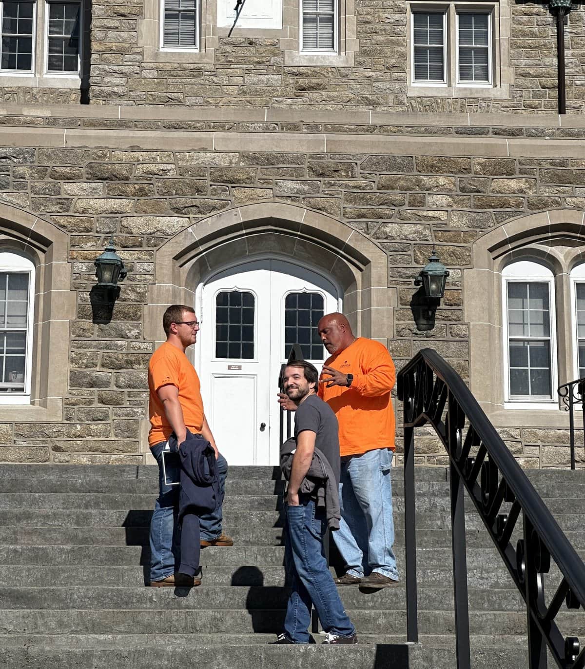 a group of Moser team members standing on stairs outside a building