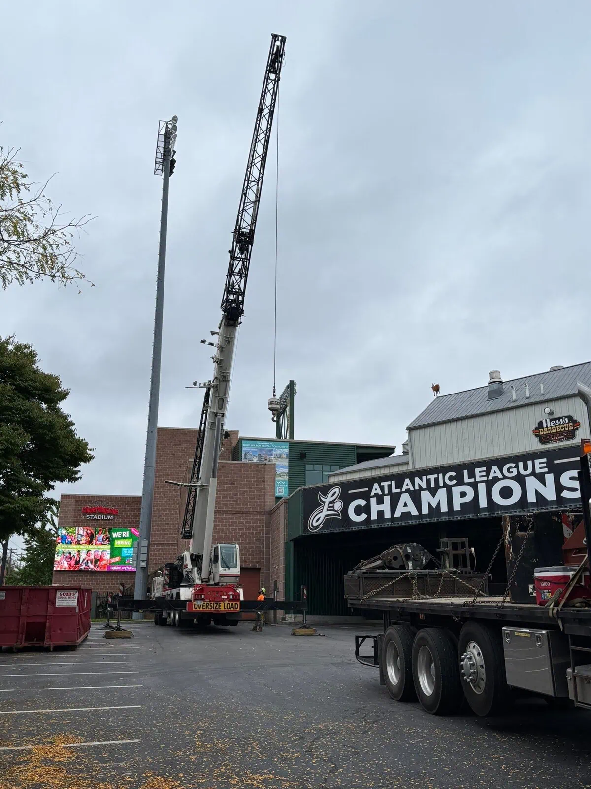 a crane on a truck operating for a roof replacement